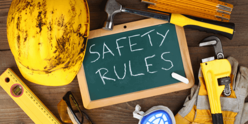 Safety rules displayed amidst construction tools.