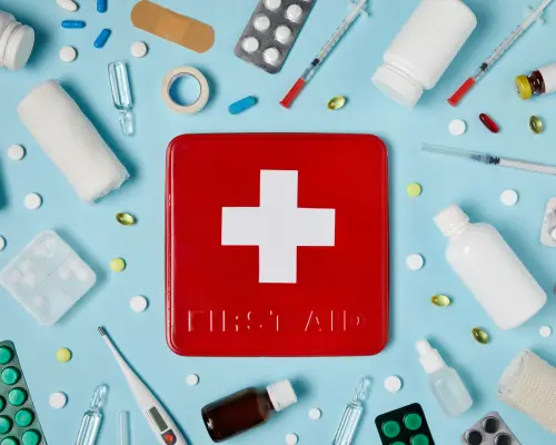 First aid icon surrounded by medical supplies representing emergency care and safety training