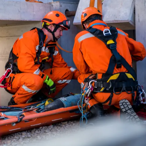 Emergency response team conducting confined space rescue training with harnesses, helmets, and retrieval equipment at industrial worksite in Queensland.