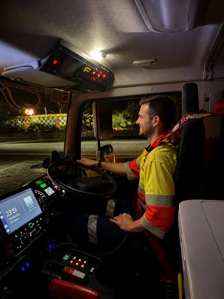 TMA operator driving truck-mounted attenuator vehicle during night roadworks in Queensland traffic management