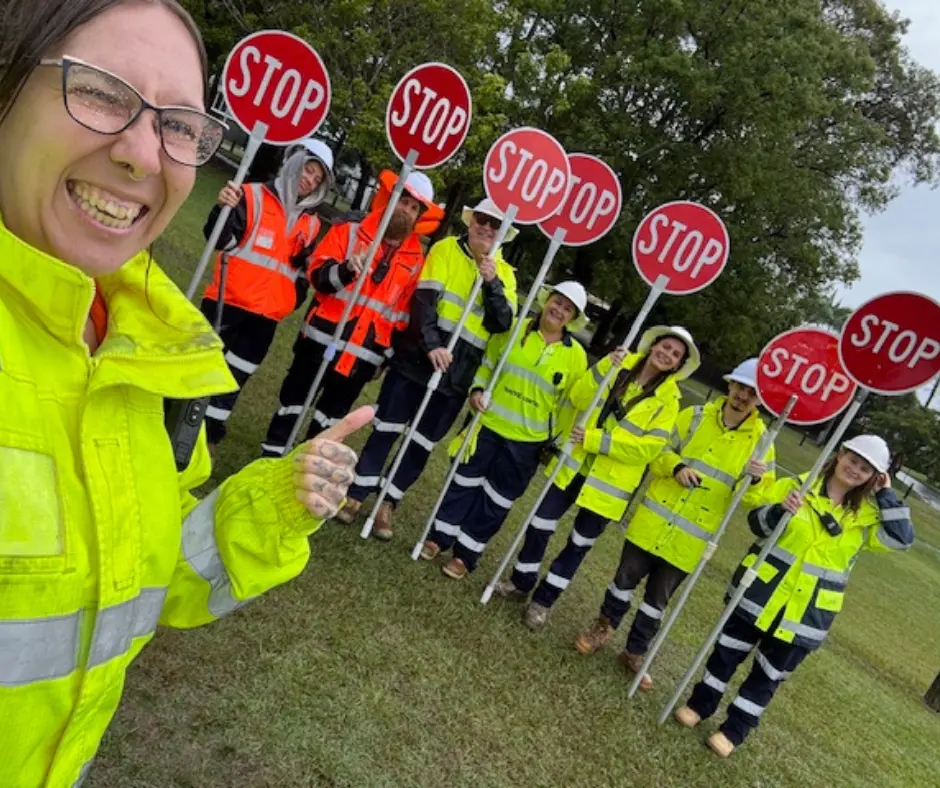 Traffic Control training students participating in practical stop/slow bat exercises during a nationally recognised Traffic Control course in Queensland, guided by an experienced Upskills QLD trainer.