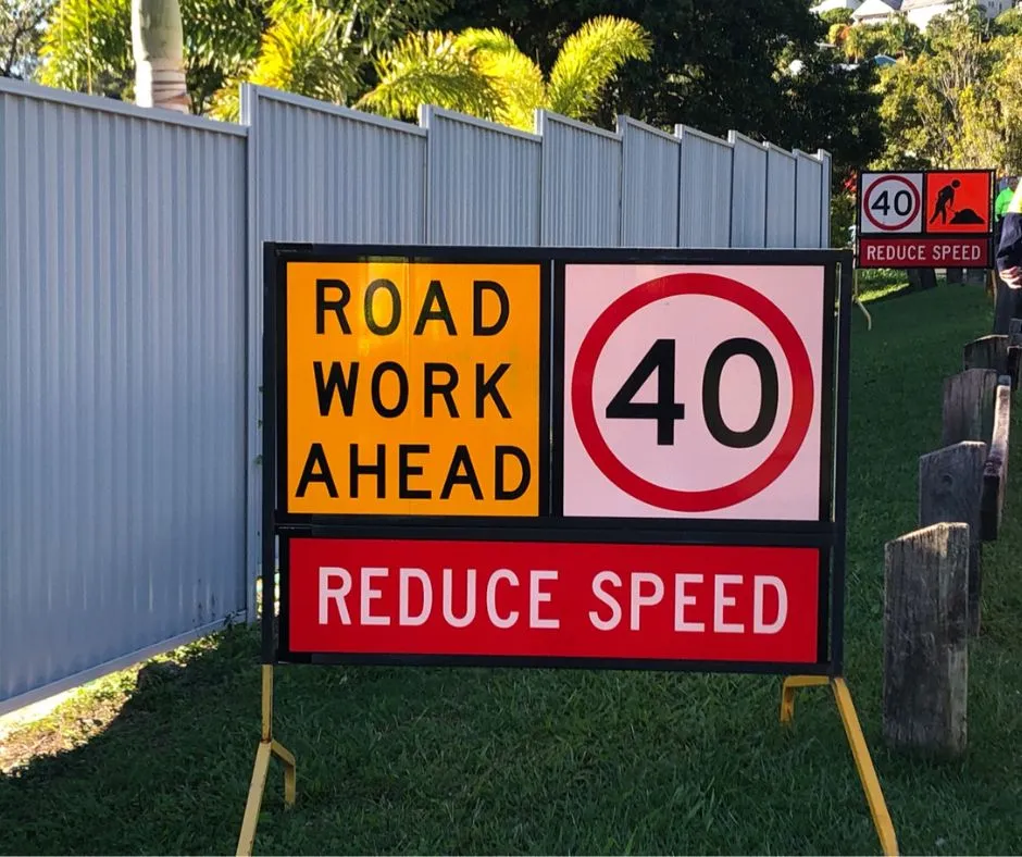 Road work ahead sign displaying a 40 km/h speed limit and reduce speed warning for a temporary traffic management zone in Queensland.