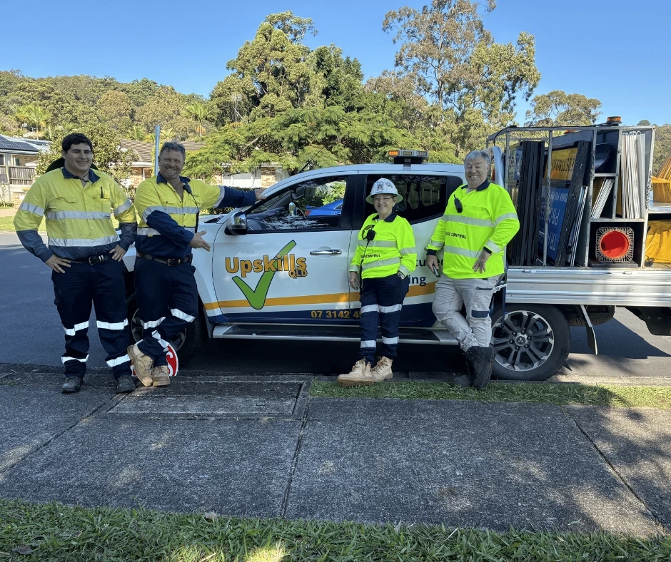 Upskills QLD trainees completing practical Traffic management in Sunshine Coast training, standing beside a traffic management training vehicle and equipment.
